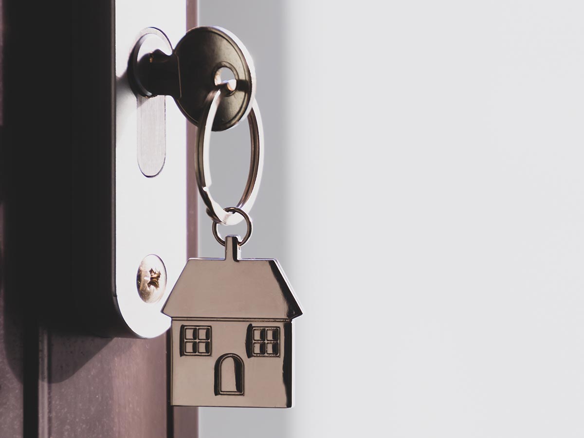 House key on a house keychain in a front door lock