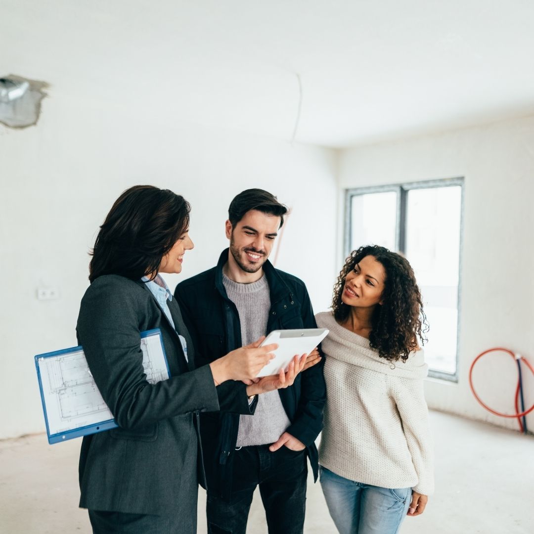People looking at loan documents with an agent.