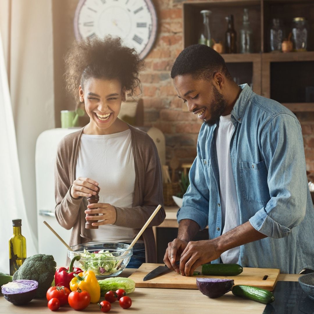 A couple cooking together.