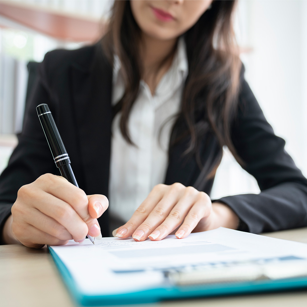 Woman signing paperwork