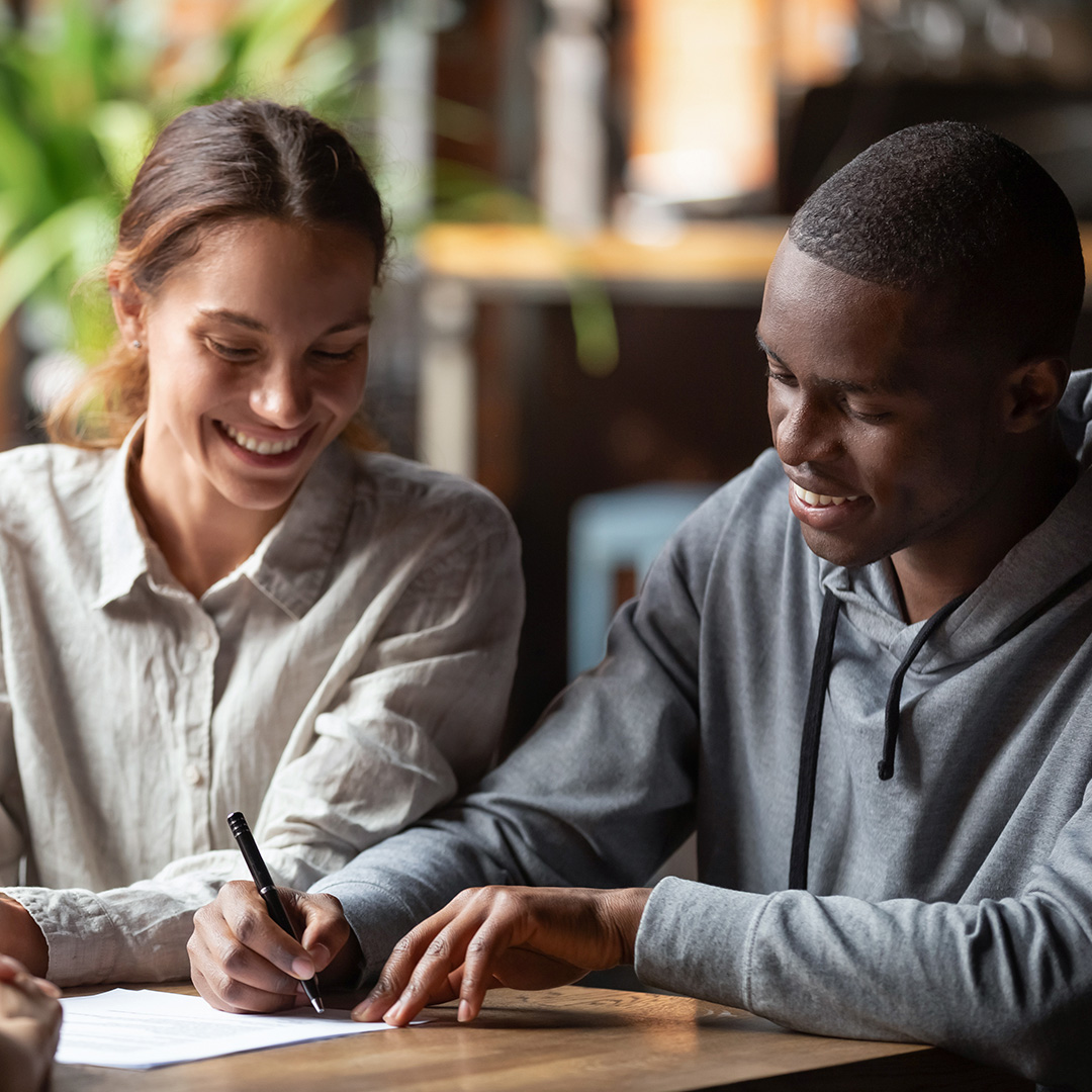 Couple signing paperwork