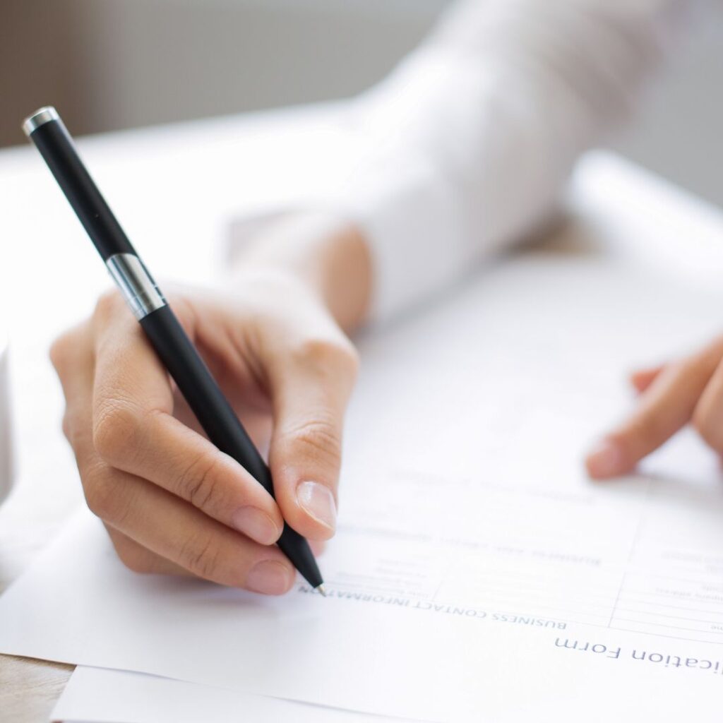 Person filling out paperwork