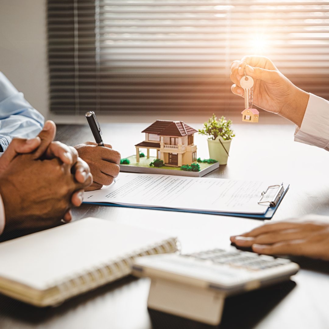 people with house keys over paperwork