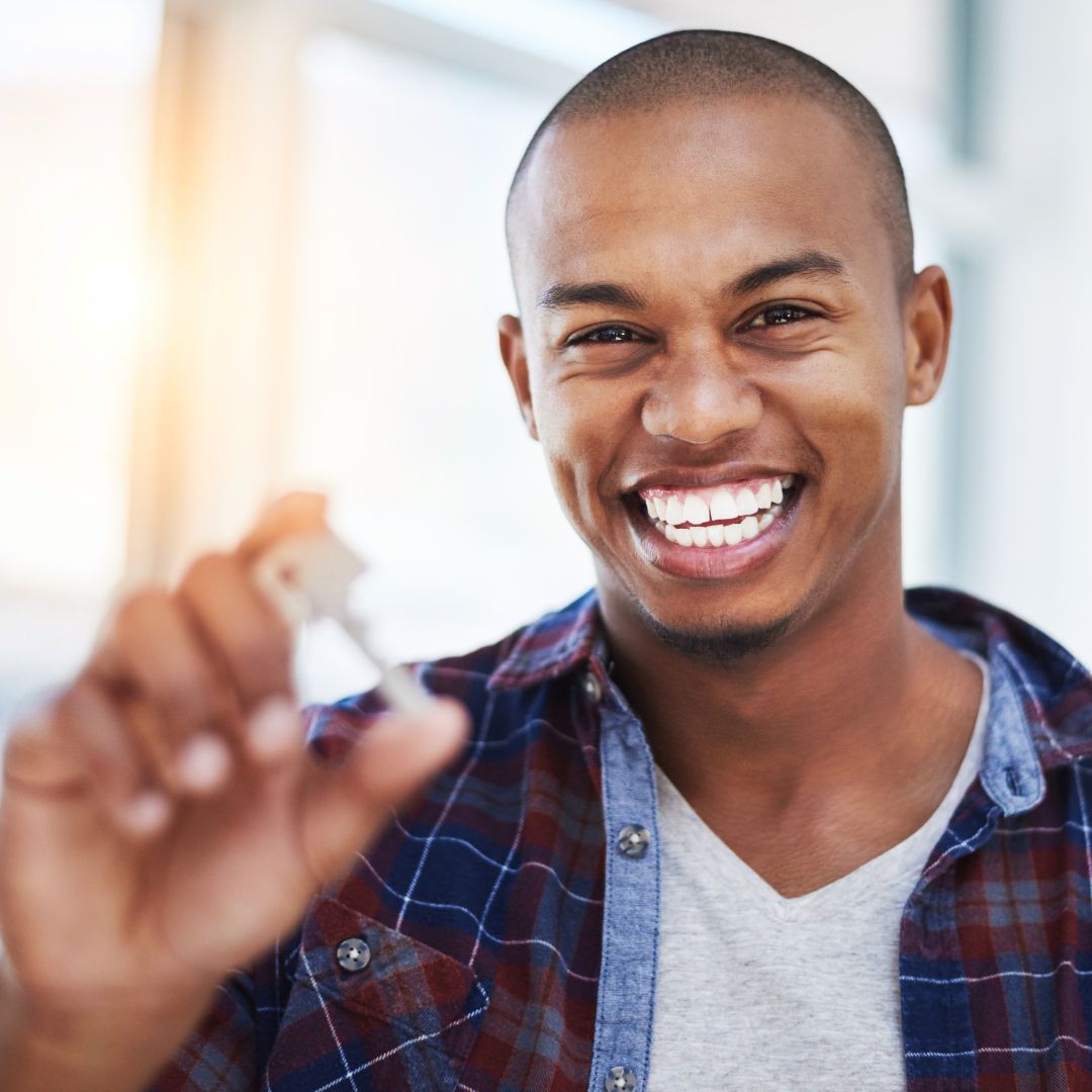 man smiling with house keys