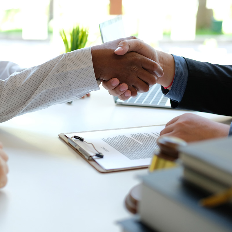 handshake across desk