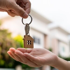 Person handing someone a house key