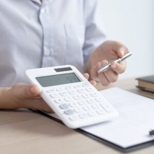 Person pointing at a calculator
