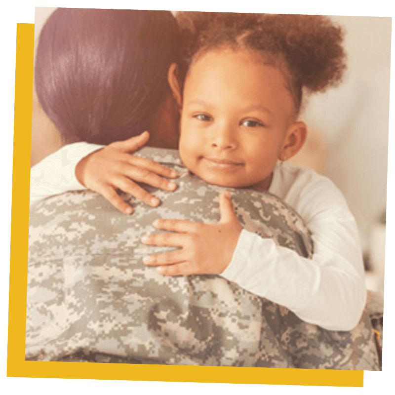veteran hugging child
