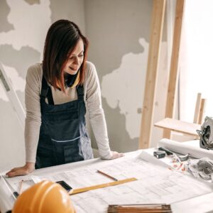 woman looks over renovation plans during construction 