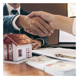 people shaking hands after purchasing a home