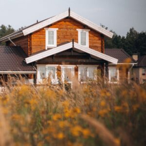 exterior of house with wood siding with wildflowers in the foreground