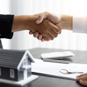 People shake hands after home agreement